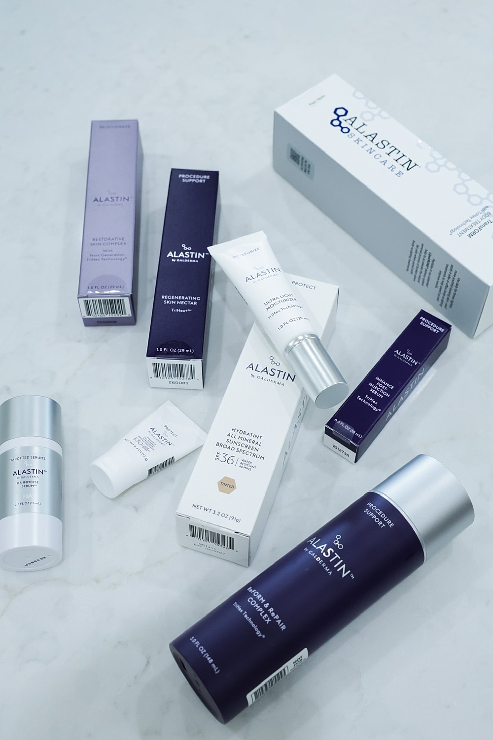 Assorted Alastin skincare products on a surface.