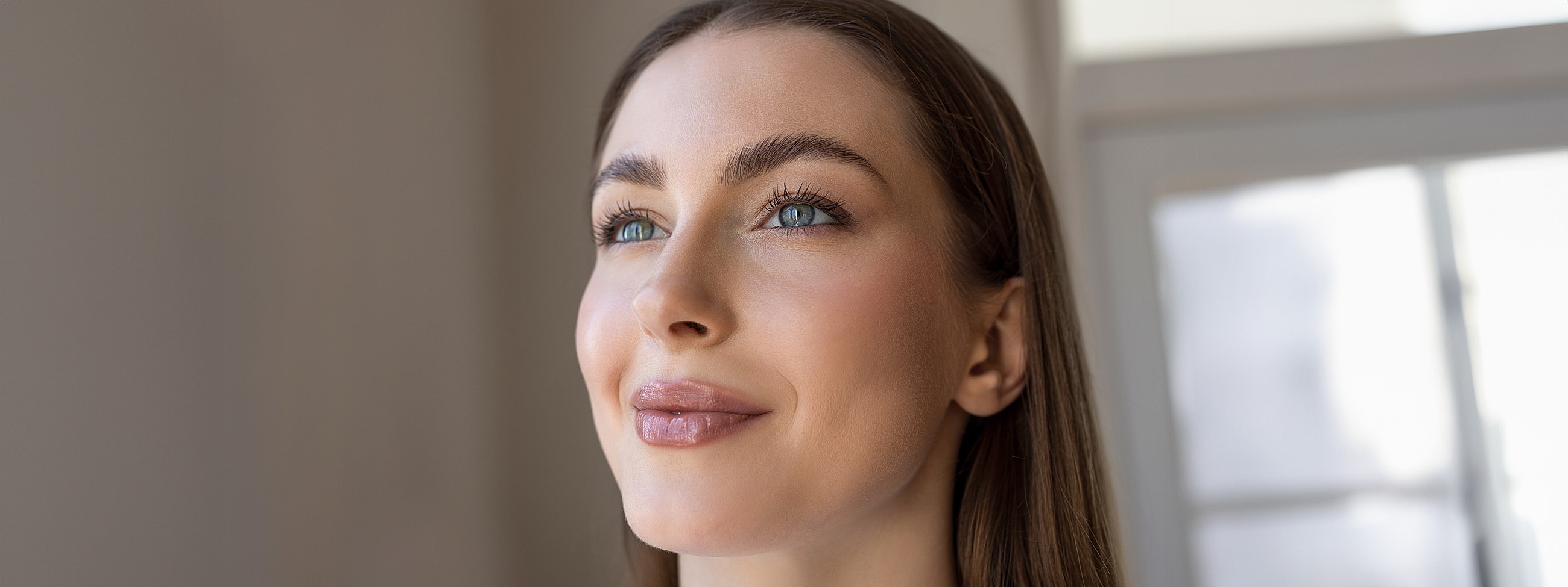 Smiling woman with long hair and bright eyes